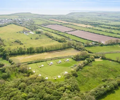 green geodesic domes with stack, bird's-eye view