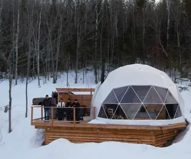 group of people standing on right side white geodesic dome on terrace