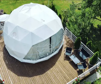 white geodesic dome on wooden deck in the garden