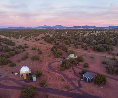 two geodesic dome standing in the middle of desert