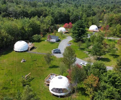 white geodesic dome on the green square, aerial view