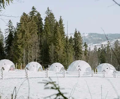 white geodesic domes in winter in mountain