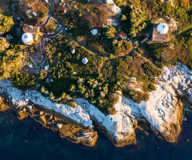 view from drone of two white geodesic domes on the island