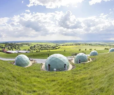 green geodesic domes at the hill