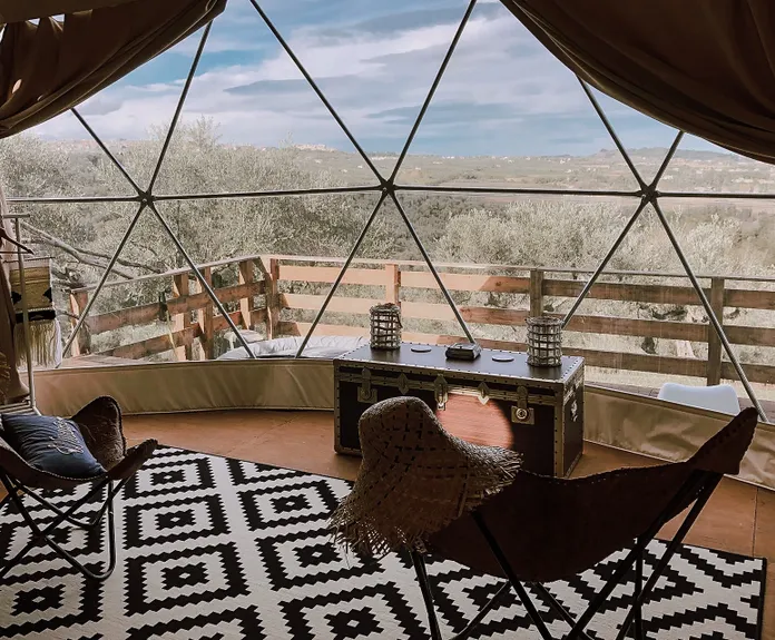 interior of geodesic dome with view at window and nature