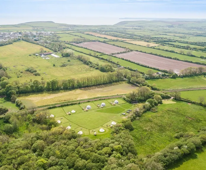 green geodesic domes with stack, bird's-eye view