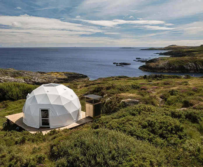 white geodesic dome on wooden deck on the hill