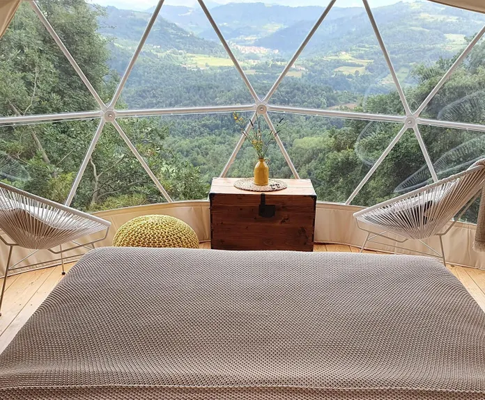 bed inside dome during day the glamping show usa