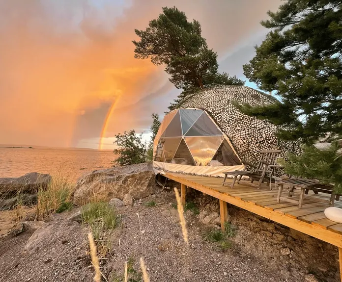 sunset view and geodesic dome on the coast of lake
