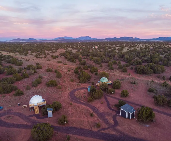 two geodesic dome standing in the middle of desert