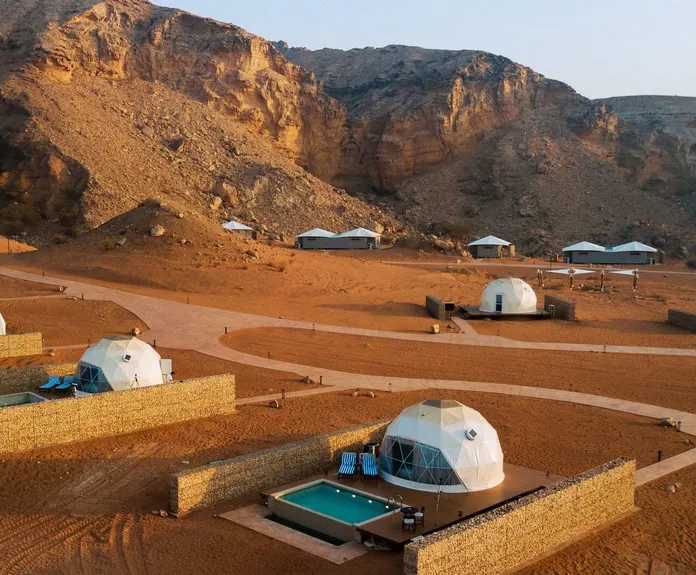 eight white geodesic domes on the desert