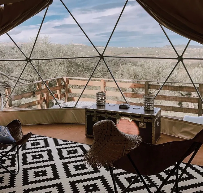 interior of geodesic dome with view at window and nature