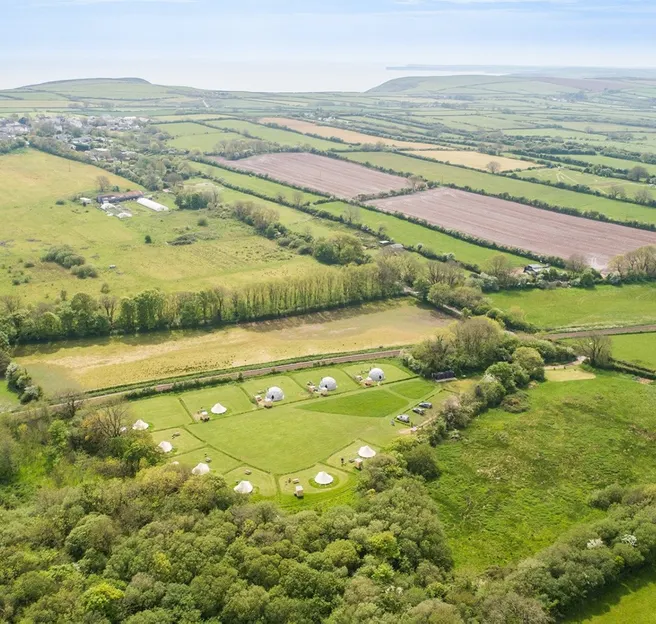green geodesic domes with stack, bird's-eye view