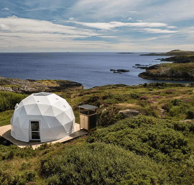 white geodesic dome on wooden deck on the hill