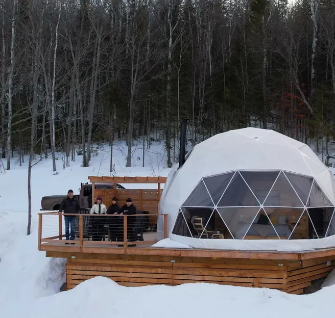 group of people standing on right side white geodesic dome on terrace