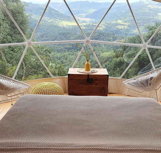 bed inside dome during day the glamping show usa