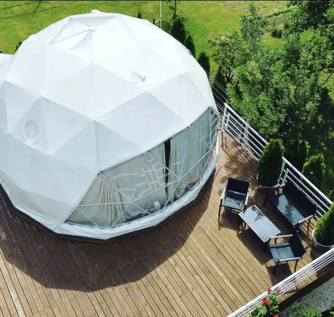 white geodesic dome on wooden deck in the garden