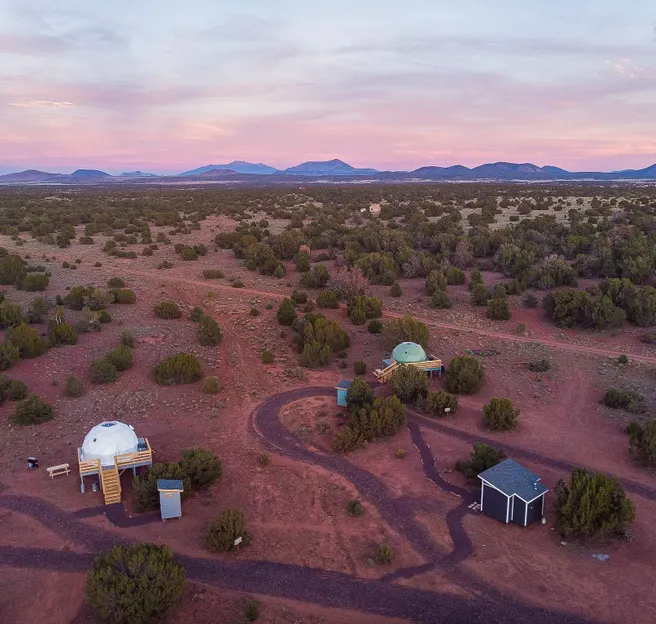 two geodesic dome standing in the middle of desert