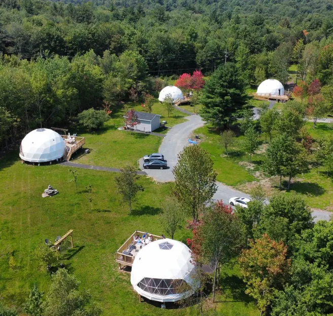 white geodesic dome on the green square, aerial view