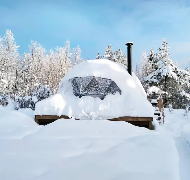 glamping dome covered in snow cold climate
