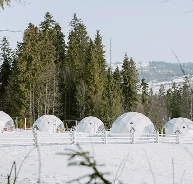 white geodesic domes in winter in mountain