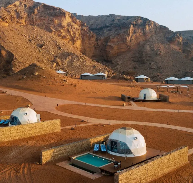 eight white geodesic domes on the desert