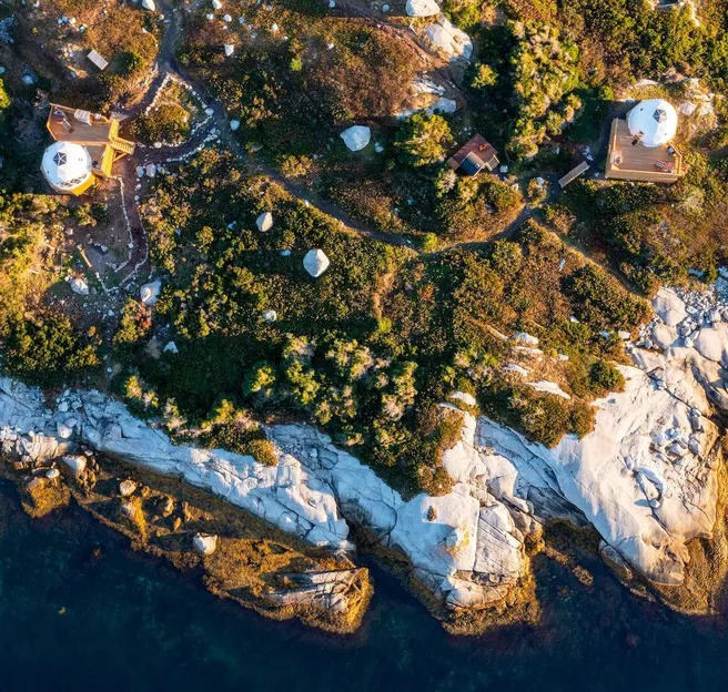 view from drone of two white geodesic domes on the island