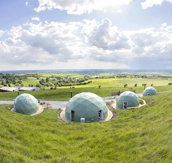 green geodesic domes at the hill
