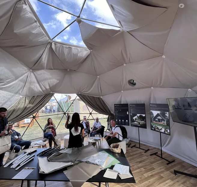 interior of geodesic dome with people while event Glamping Show Americas 2023, Colorado, USA