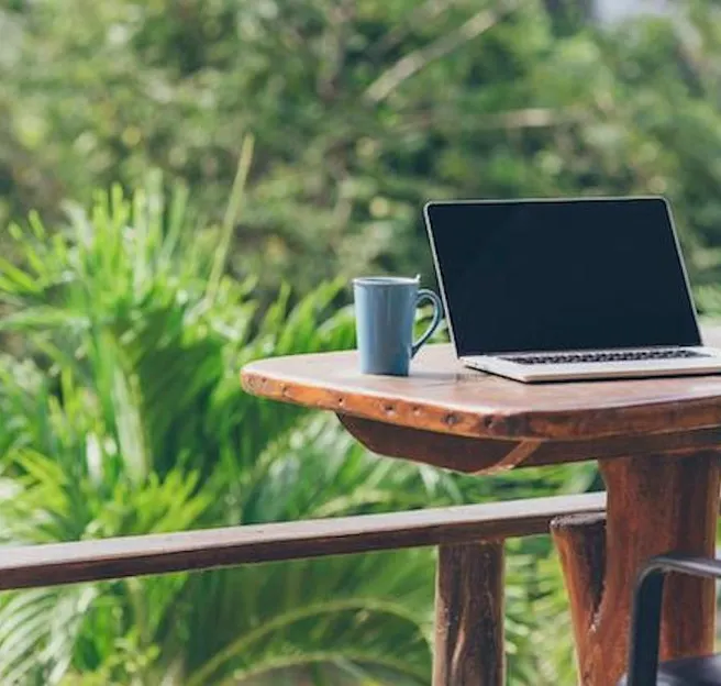 laptop on desk outside 