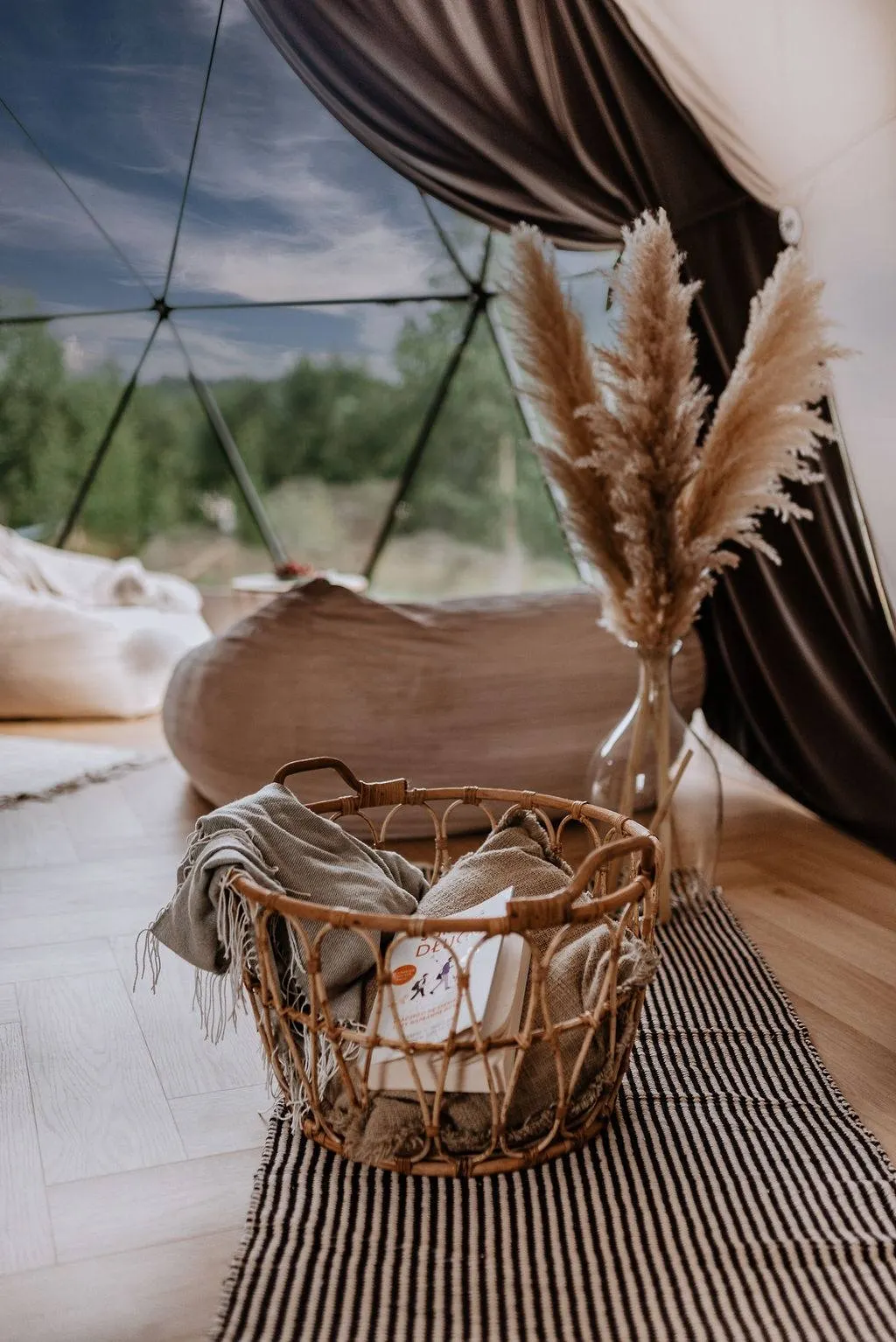 inside of geodesic dome with some armchairs and a window