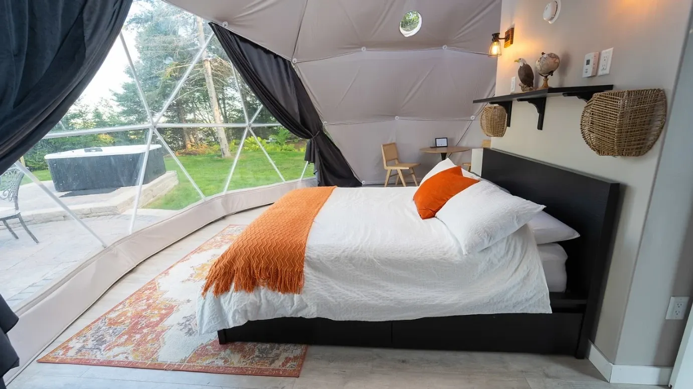 Interior of a geodesic dome with a view of the bed and window