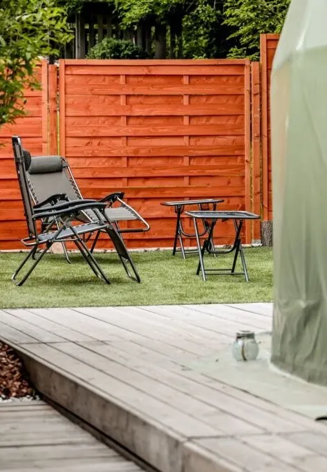 green geodesic dome in the garden with some armchairs and tables
