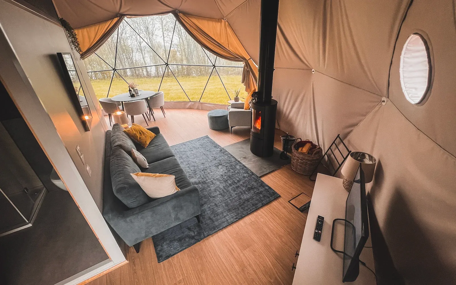 inside of geodesic dome with furniture and a view