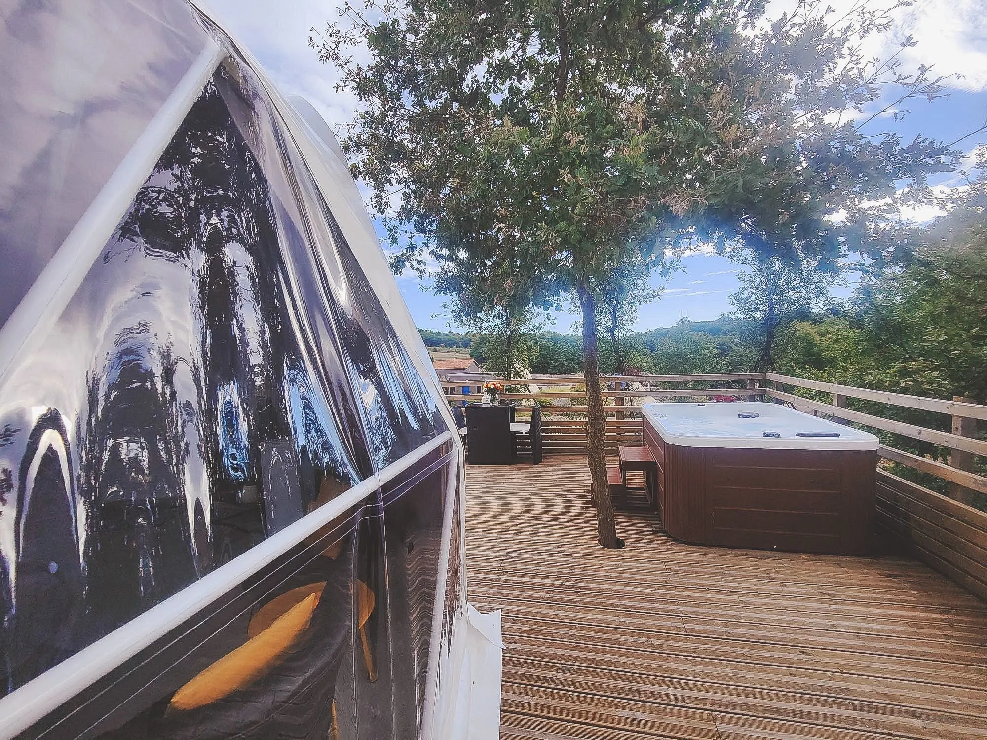 white geodesic dome on wooden deck with jacuzzi