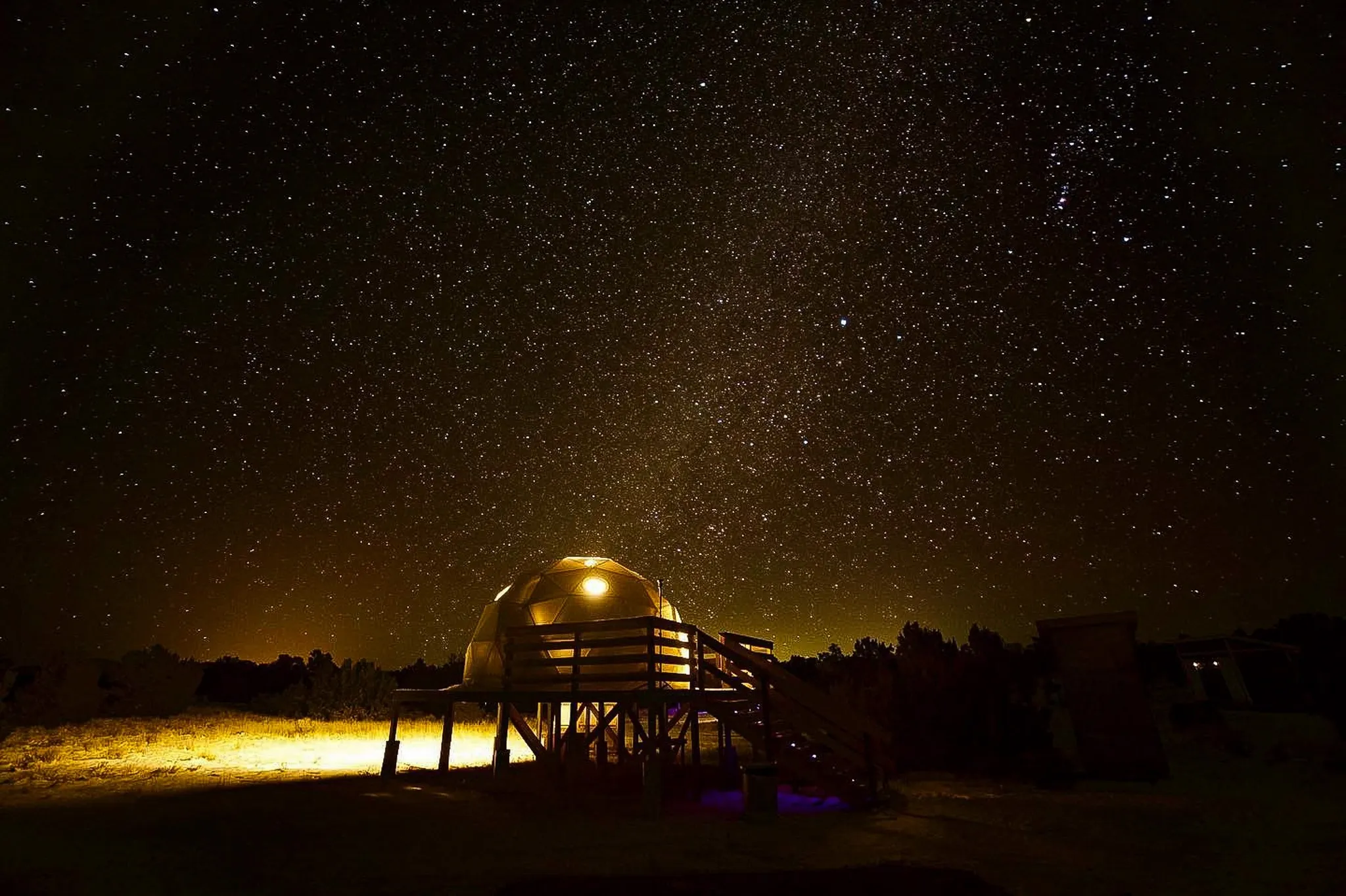 geodesic dome on wooden deck at night