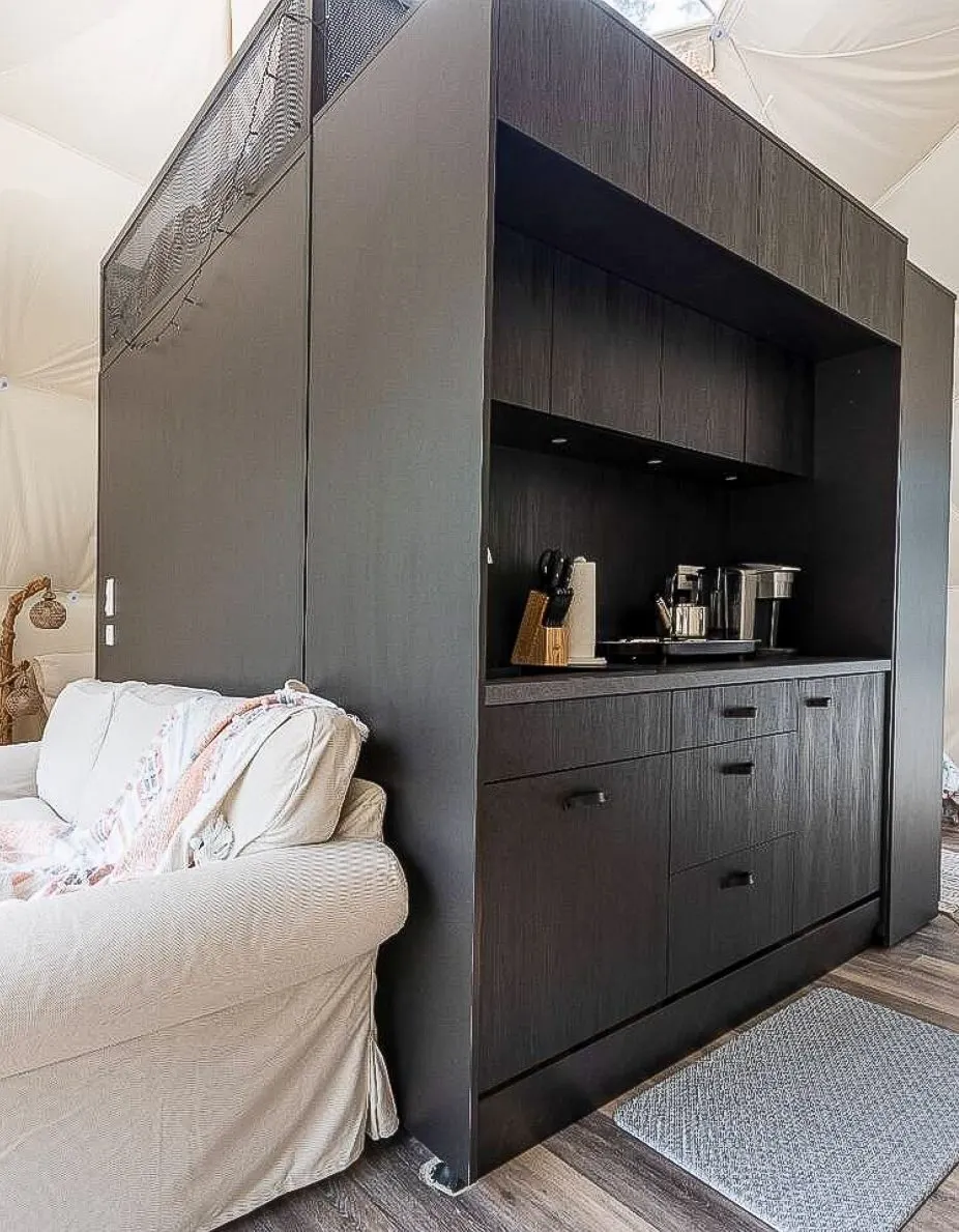 inside of geodesic dome with a interior module kitchen and a sofa