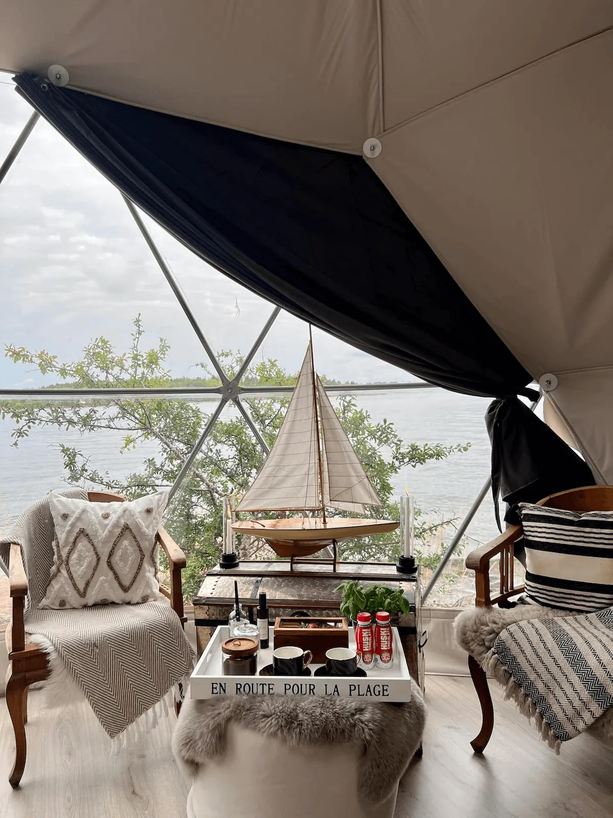 inside of geodesic dome with two armchairs and a table