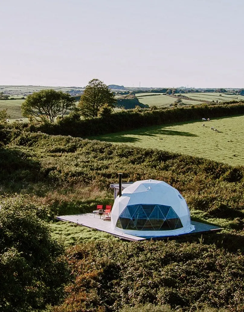 white geodesic dome with stack on the field