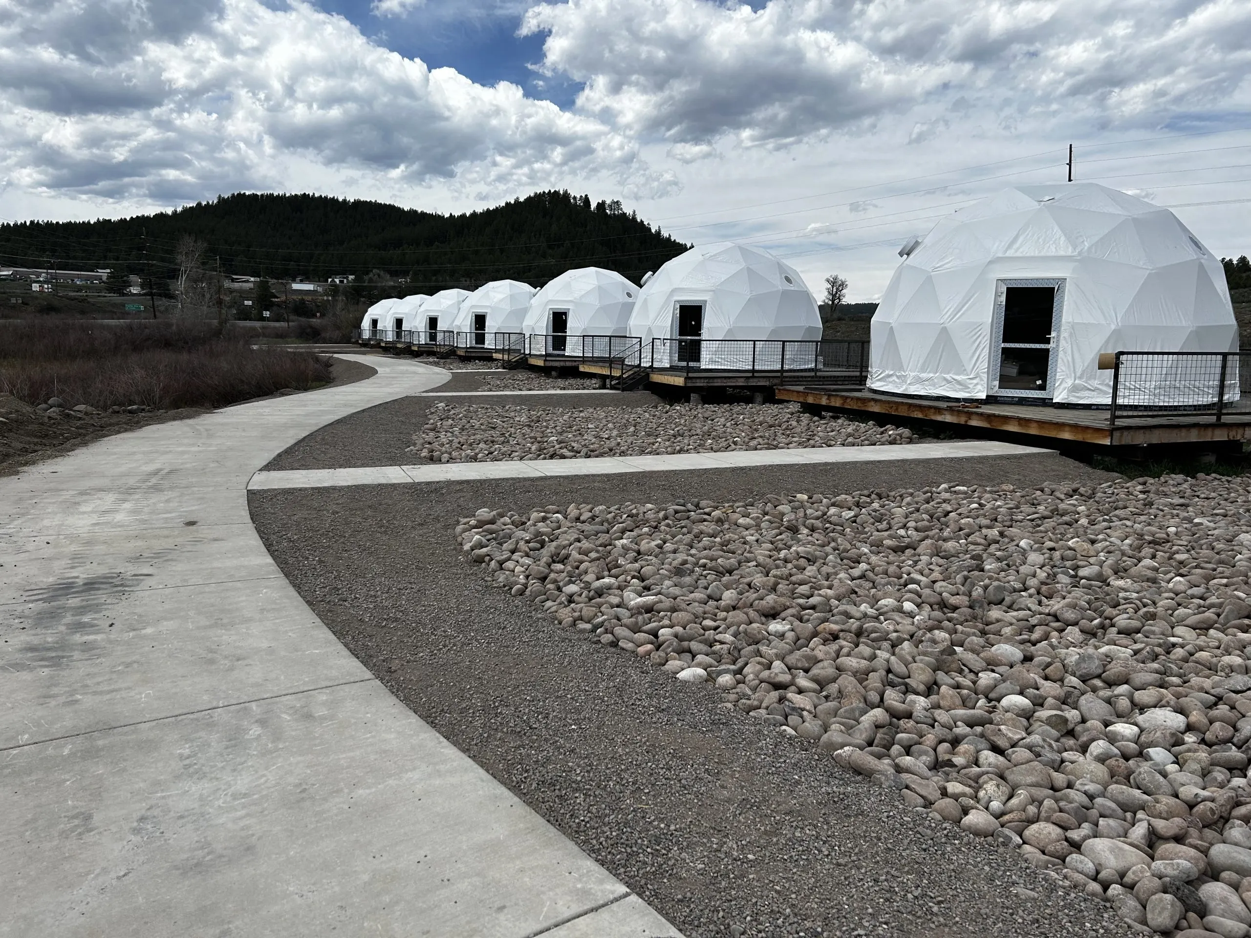 few geodesic domes on a campsite