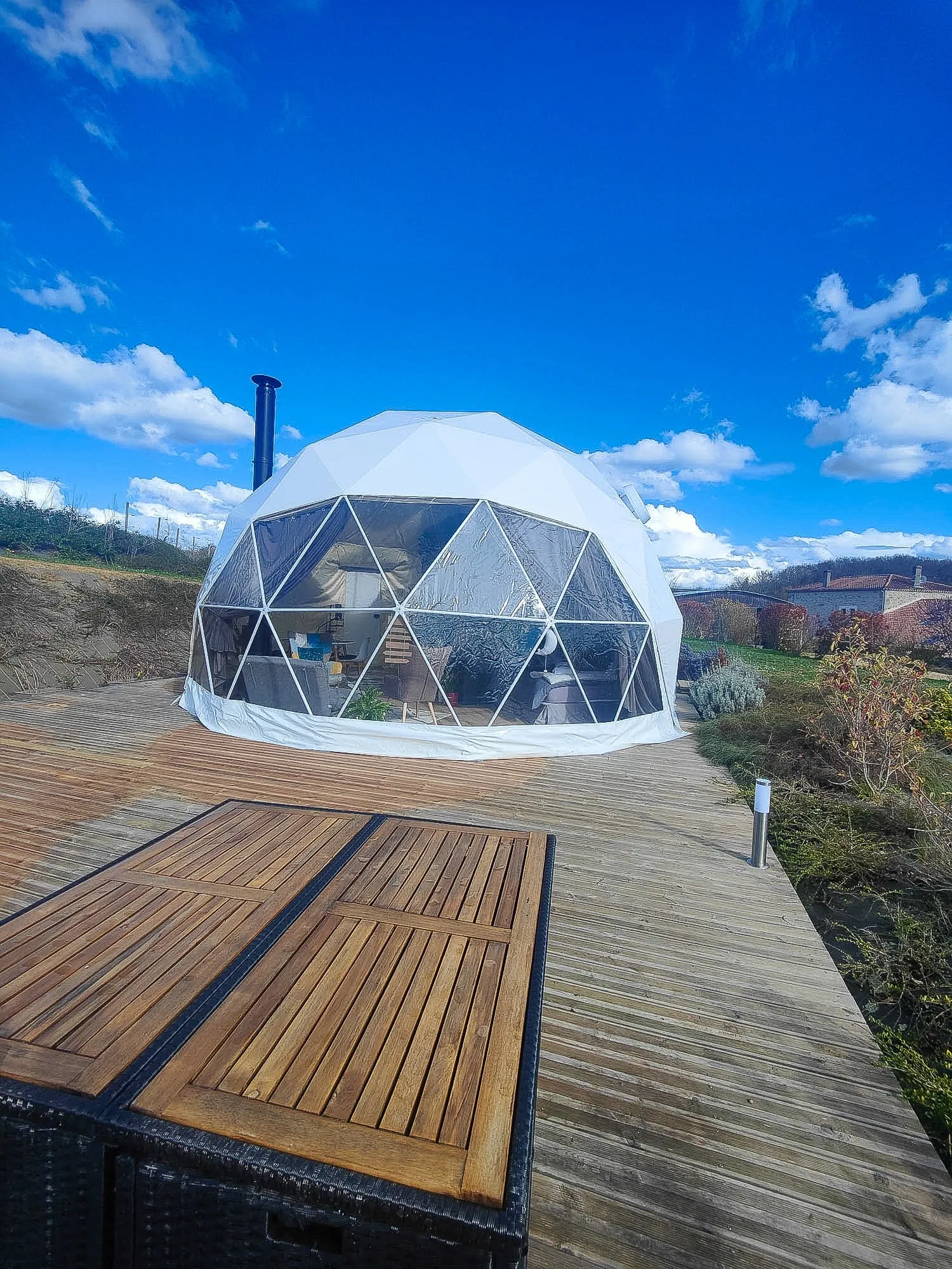 white geodesic dome on wooden deck with jacuzzi