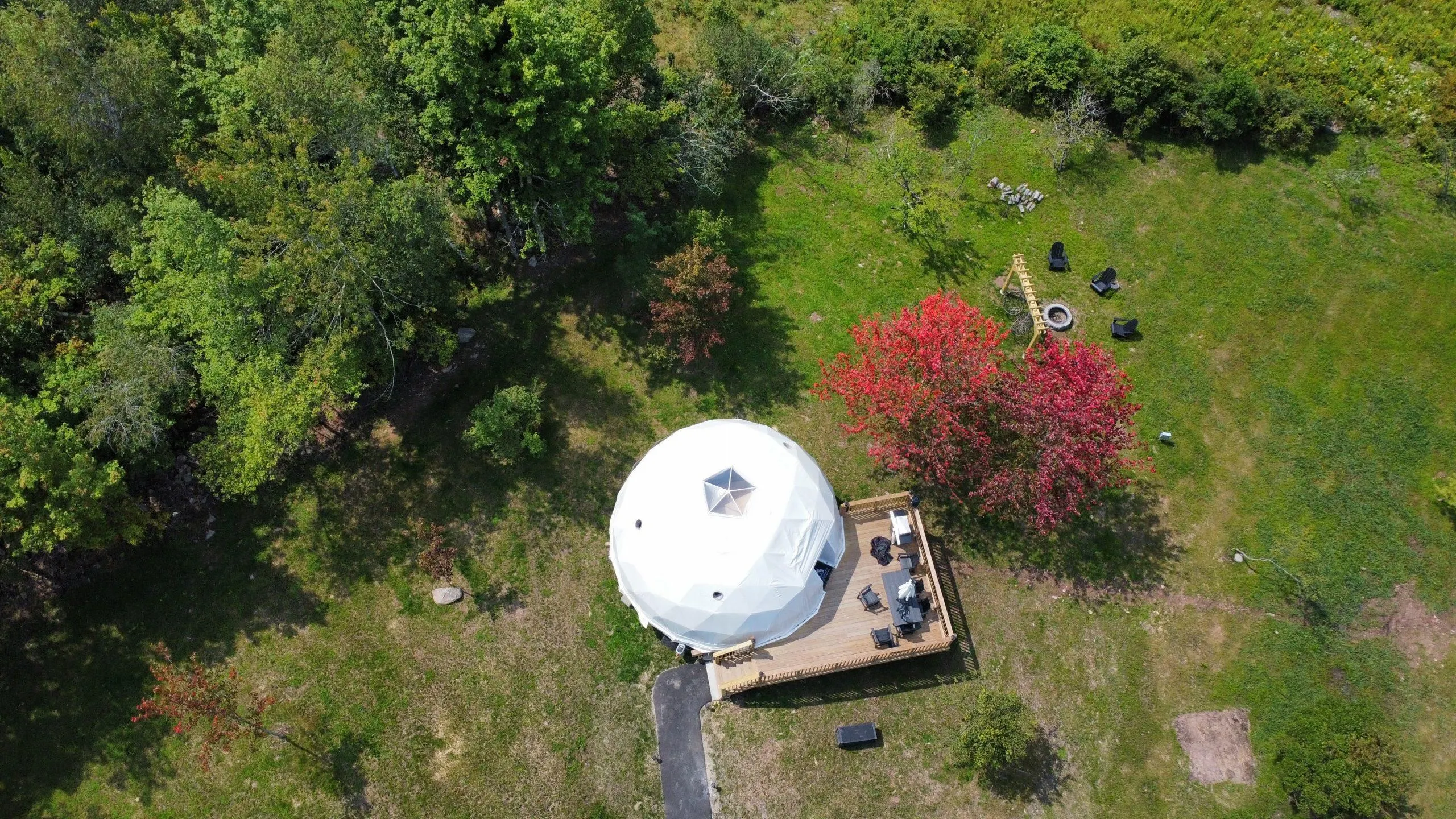 white geodesic dome on the green square, aerial view