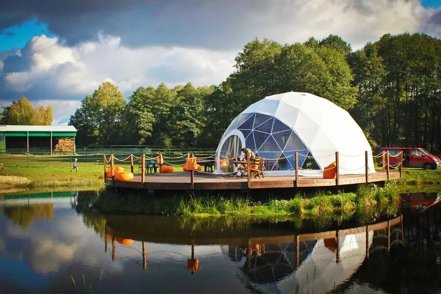 spherical-structure-set-on-a-specially-built-wooden-terrace-over-the-pond