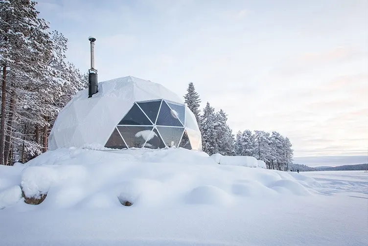 glamping dome at day covered in snow