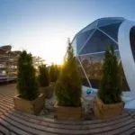 white dome tent on wooden platform in sunset