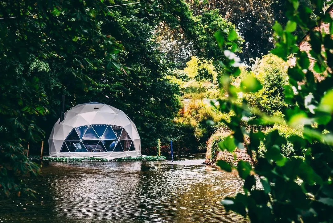 white glamping dome near the river 
