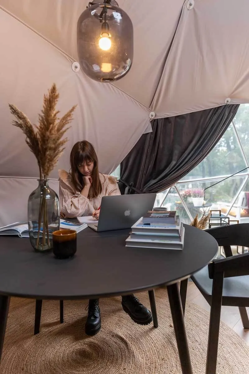 image showing woman sitting inside geodesic dome