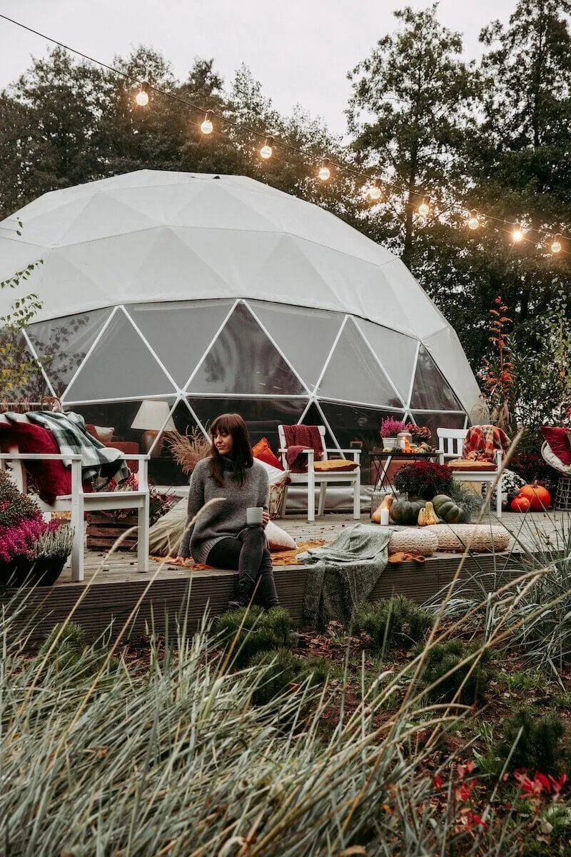 Fdomes glamping resort workcation woman sitting near geodesic dome