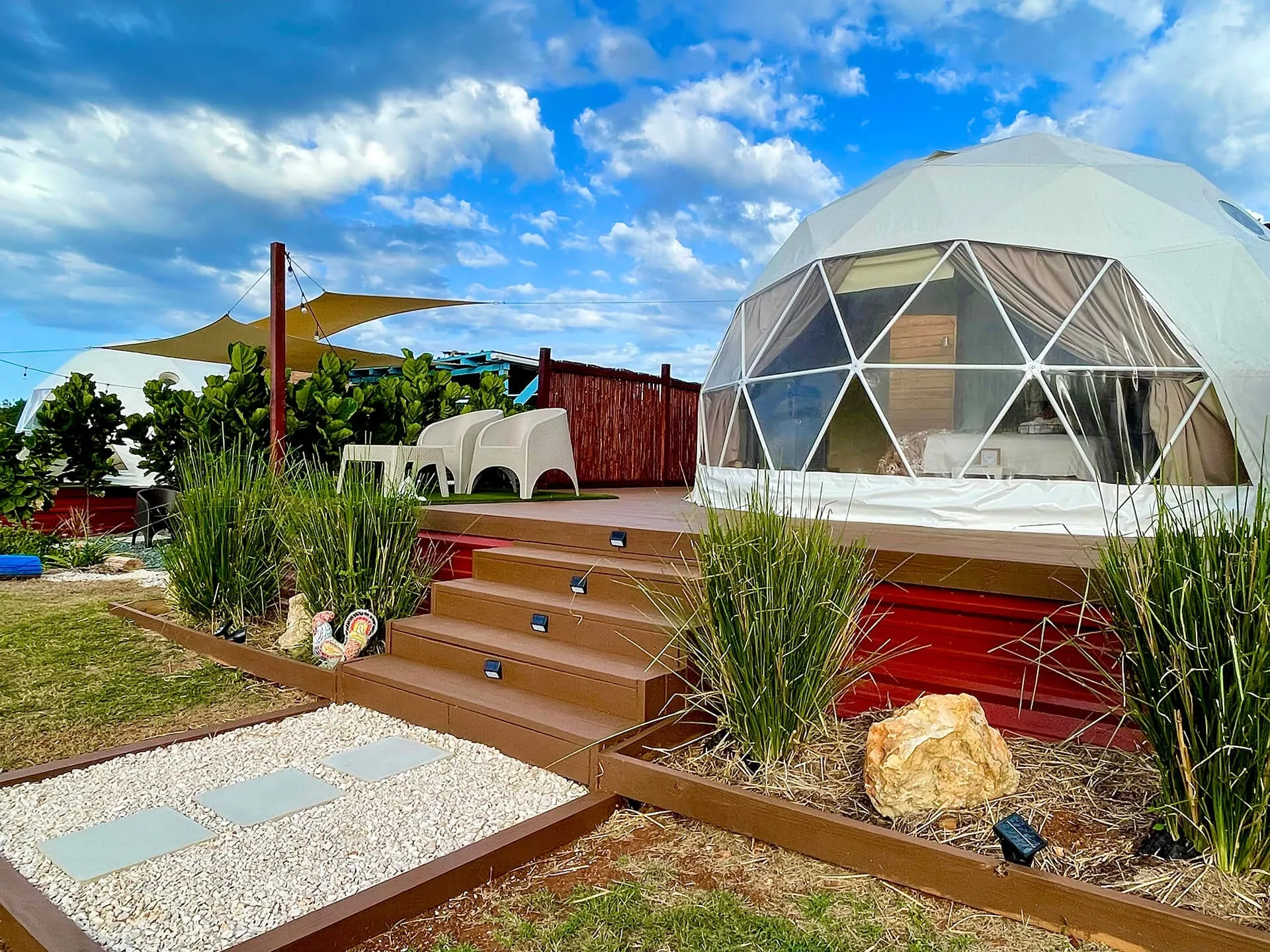 white geodesic dome on wooden deck