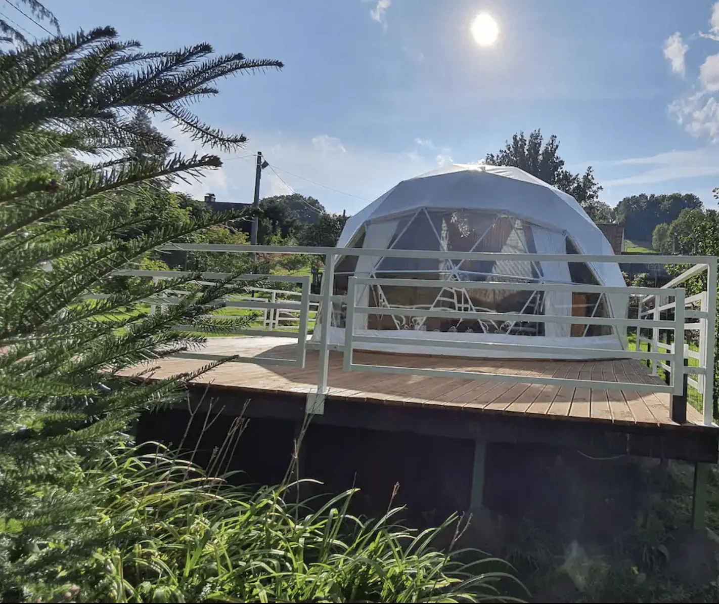 white geodesic dome on wooden deck in the garden